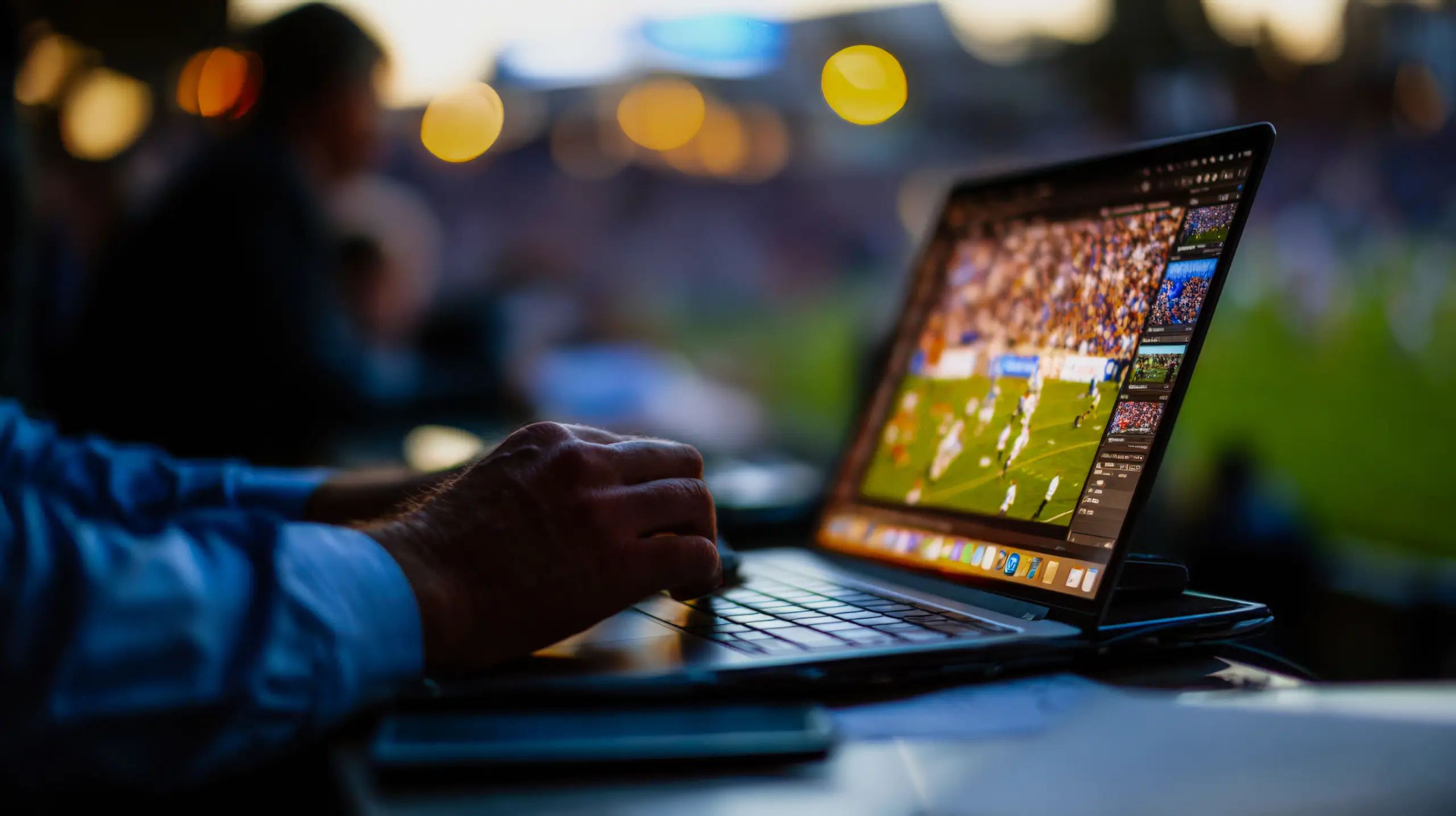 Man using laptop to watch soccer